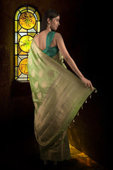 Woman in a green saree with a teal blouse posing for Chinaya