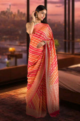Model wearing a red and orange woven georgette silk saree with intricate patterns, available at Chinaya Banaras